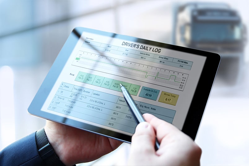 An executive reviews a driver's daily log on tablet.