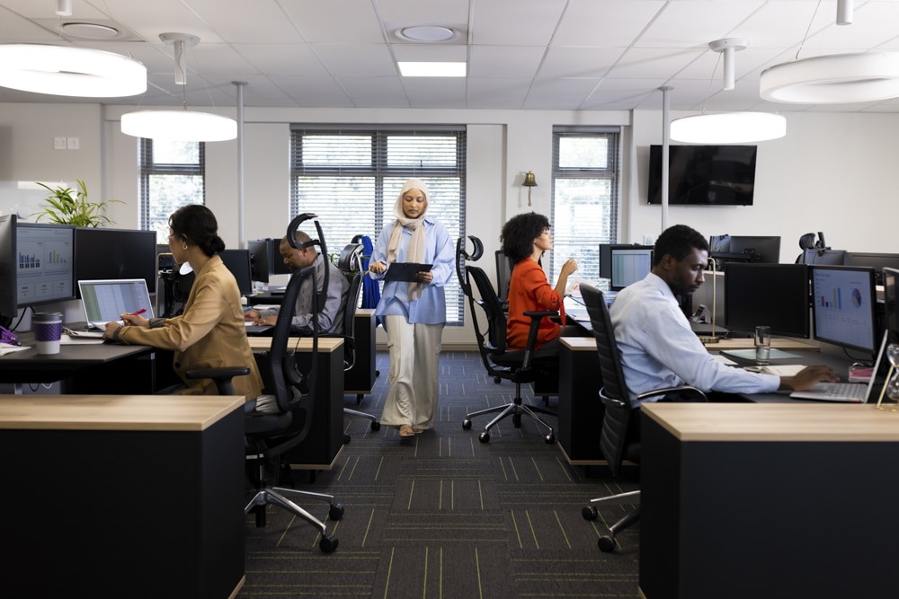 Diverse female and male businesspeople working in office with open space. Business, corporation, cooperation and working in office concept.